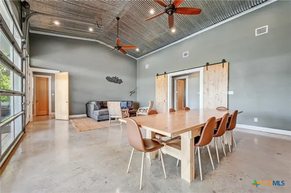 a dining room with furniture and a kitchen view