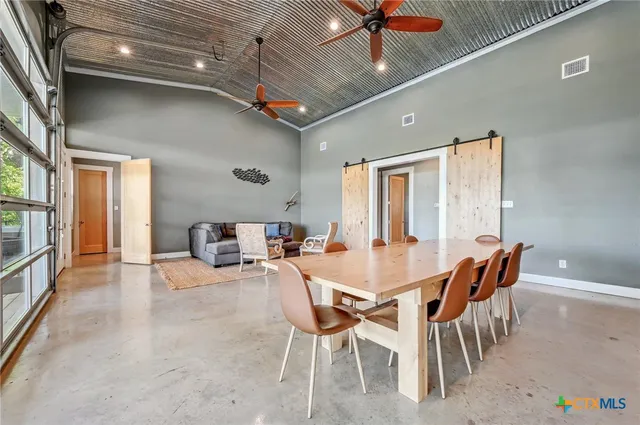 a dining room with furniture and a kitchen view
