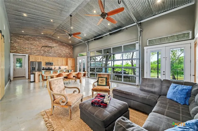 a view of a dining room with furniture and a chandelier