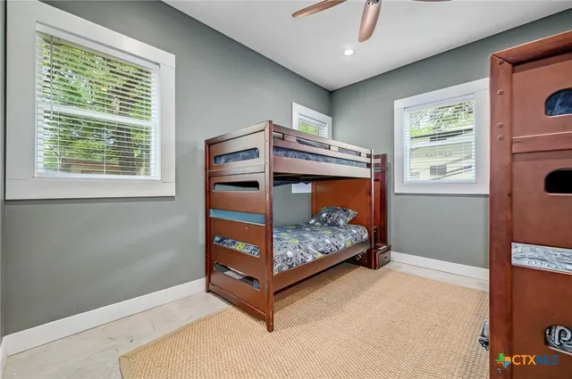 a bathroom with a granite countertop sink a large mirror and a bathtub