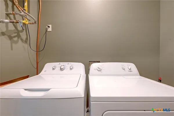a view of swimming pool with lawn chairs and plants