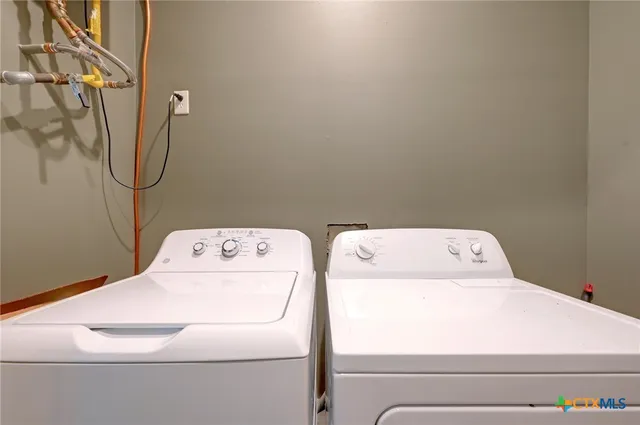a view of swimming pool with lawn chairs and plants