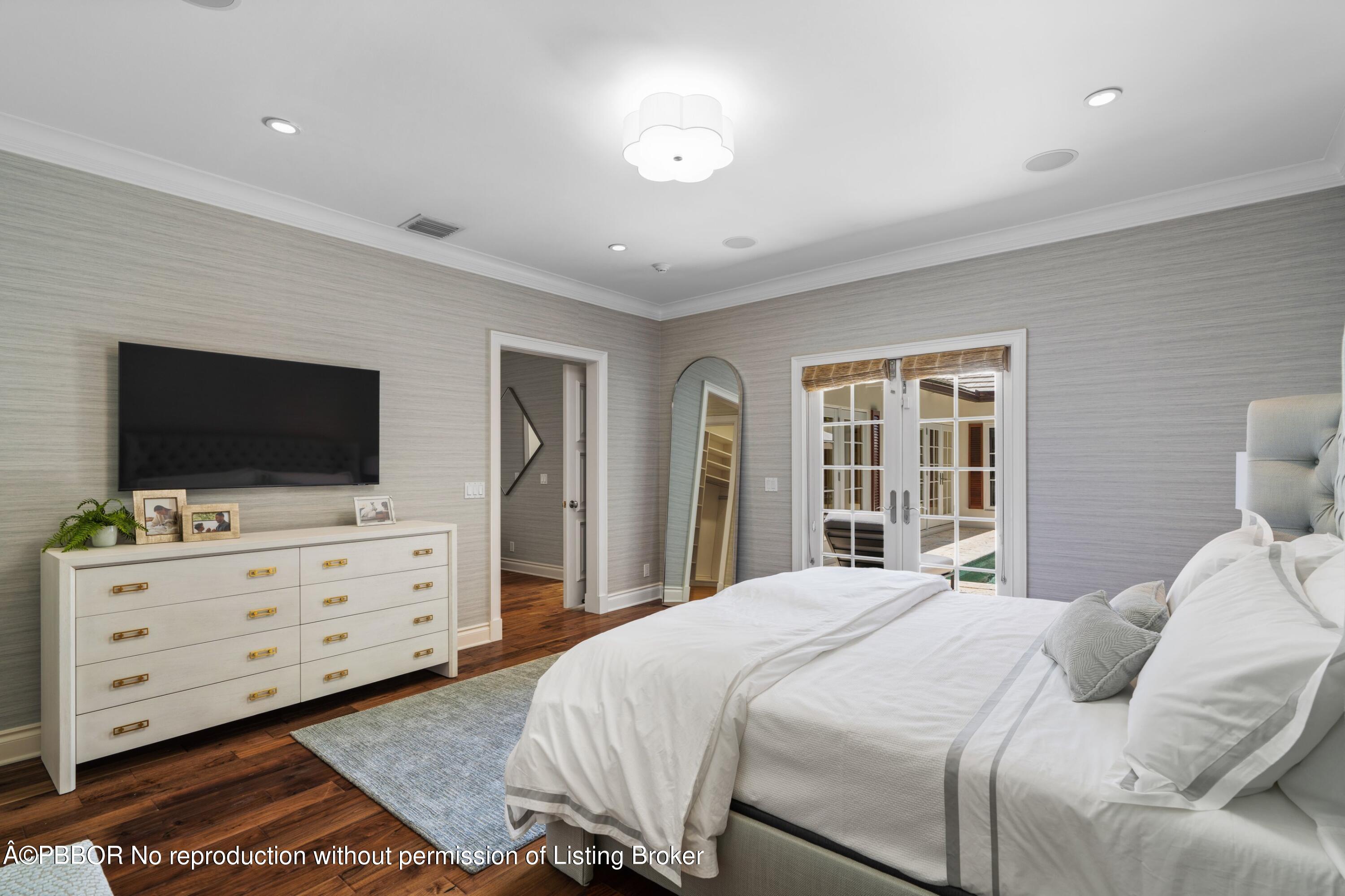 265 List Road Palm Beach, FL 33480 - Photo 14 of 26 a bedroom with a bed and wooden floor