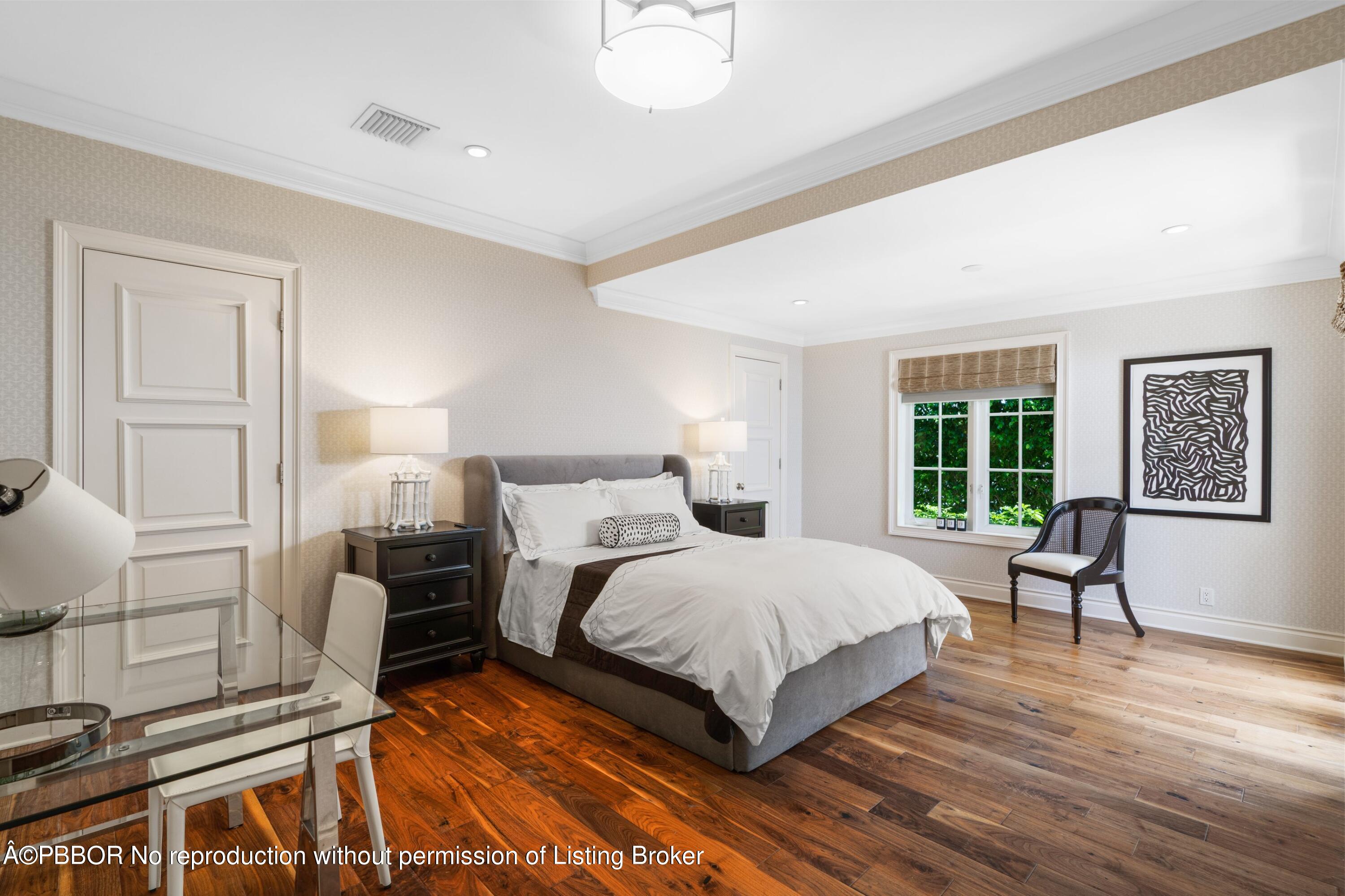 265 List Road Palm Beach, FL 33480 - Photo 18 of 26 a bedroom with a bed and wooden floor