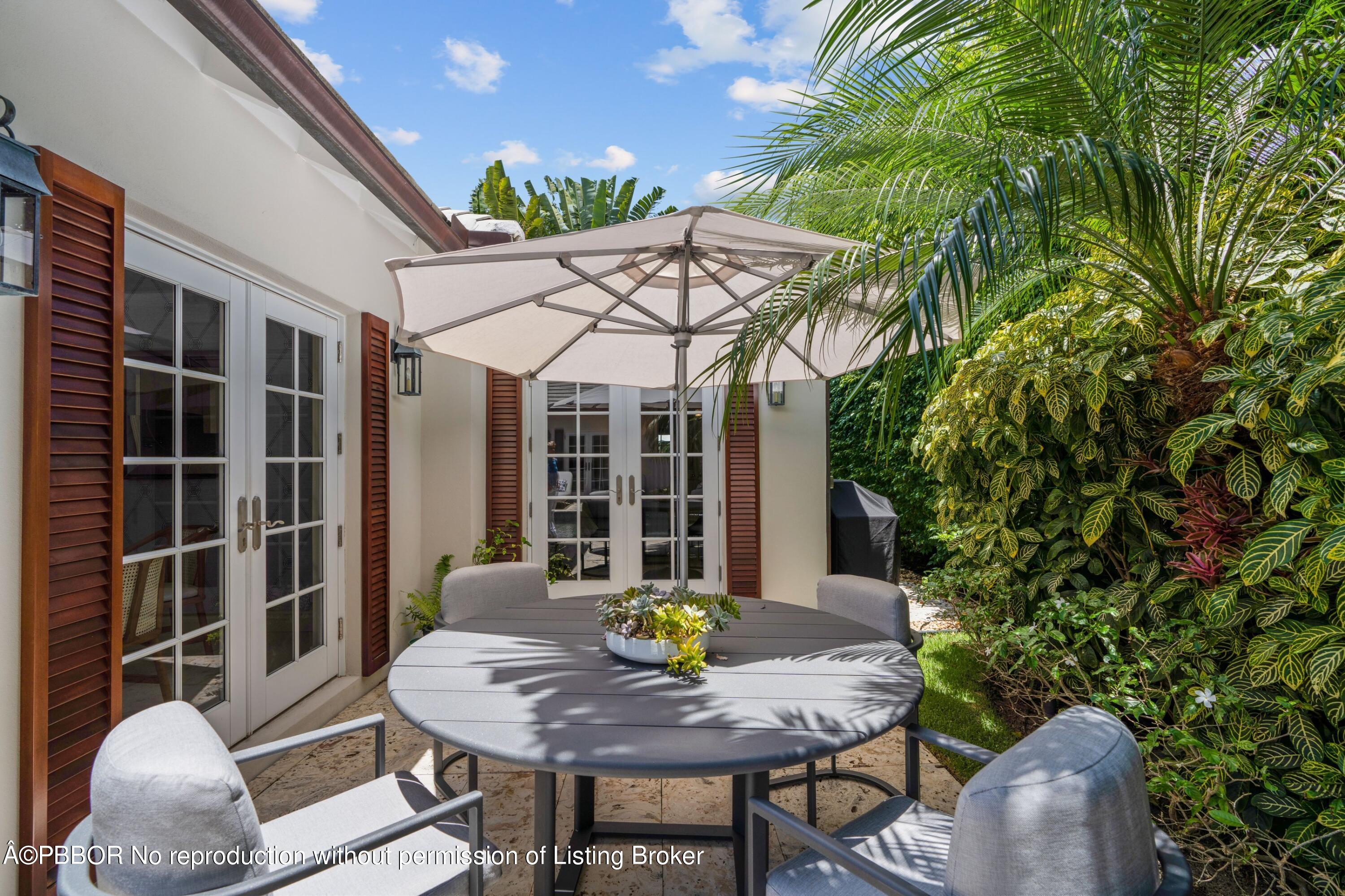 265 List Road Palm Beach, FL 33480 - Photo 23 of 26 a view of a backyard with table and chairs and potted plants
