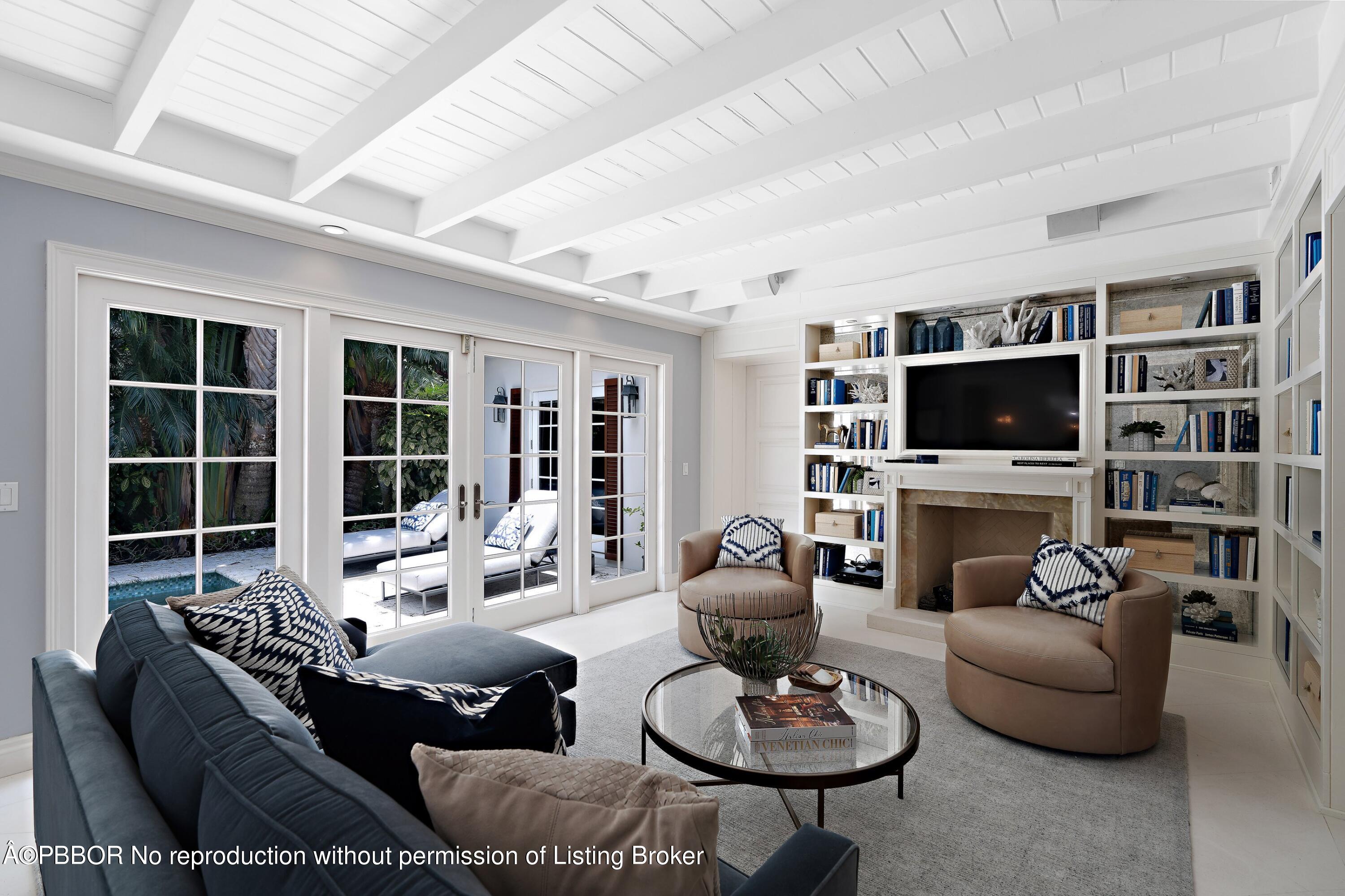 265 List Road Palm Beach, FL 33480 - Photo 8 of 26 a living room with furniture a fireplace and a flat screen tv