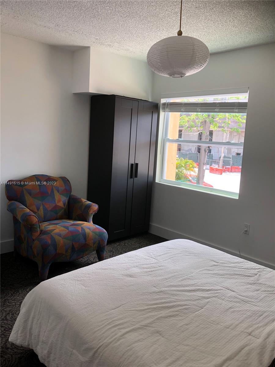 427 Southwest 7th Street, Unit 15 Miami, FL 33130 - Photo 12 of 25 a bedroom with bed and window
