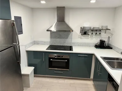 a kitchen with a stove and a refrigerator