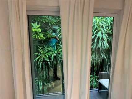 a view of a potted plant in front of a door