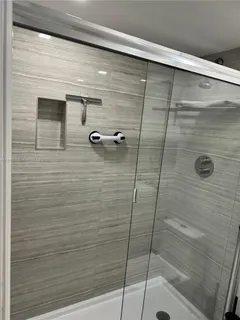 a view of a bedroom with wooden floor and chair