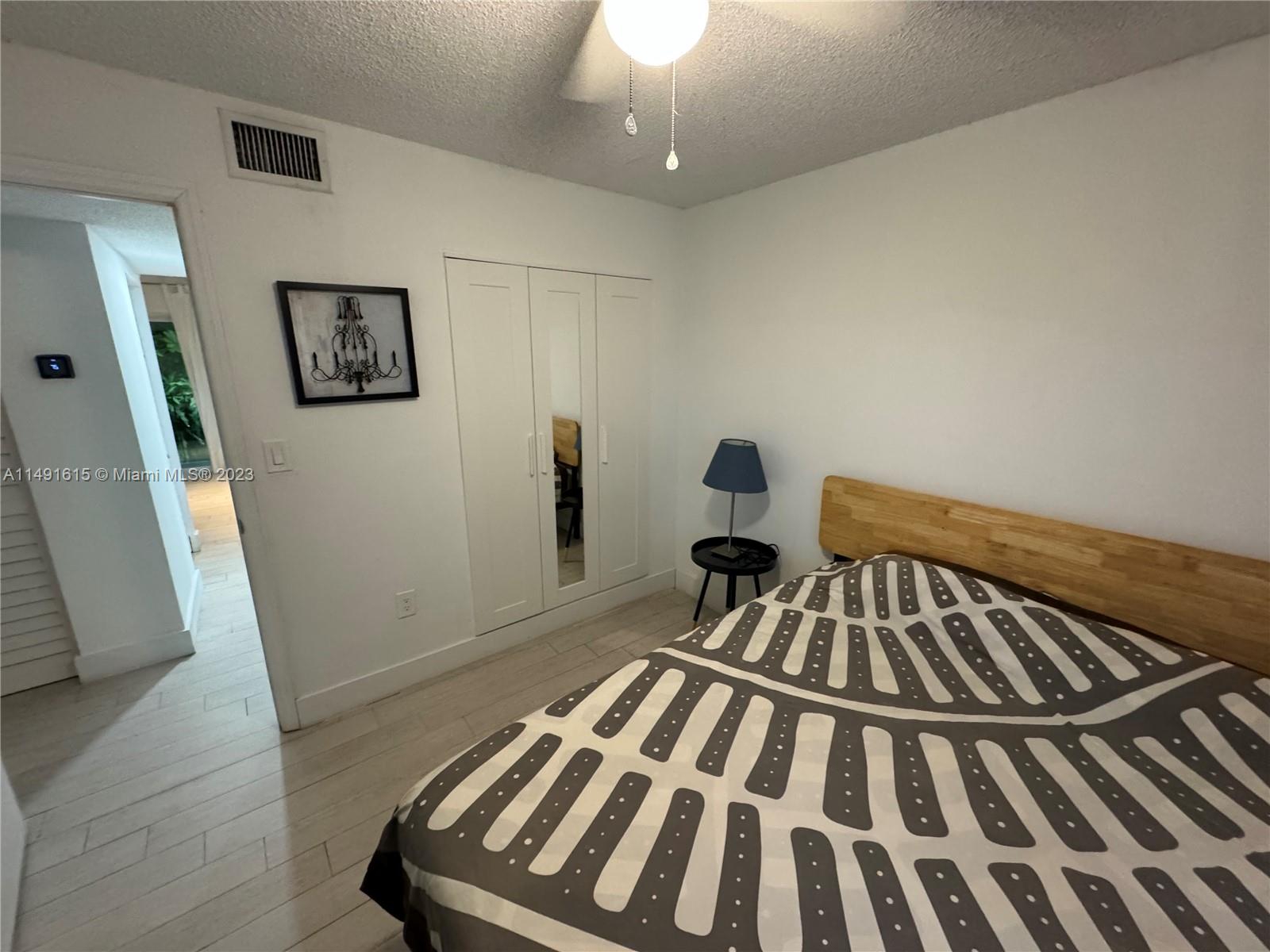 427 Southwest 7th Street, Unit 15 Miami, FL 33130 - Photo 23 of 25 a view of a bedroom with wooden floor and chair