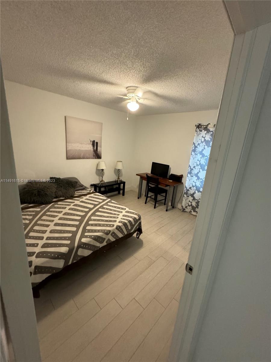 427 Southwest 7th Street, Unit 15 Miami, FL 33130 - Photo 24 of 25 a bedroom with furniture and a chandelier