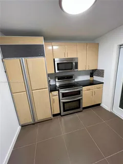 a kitchen with appliances and cabinets
