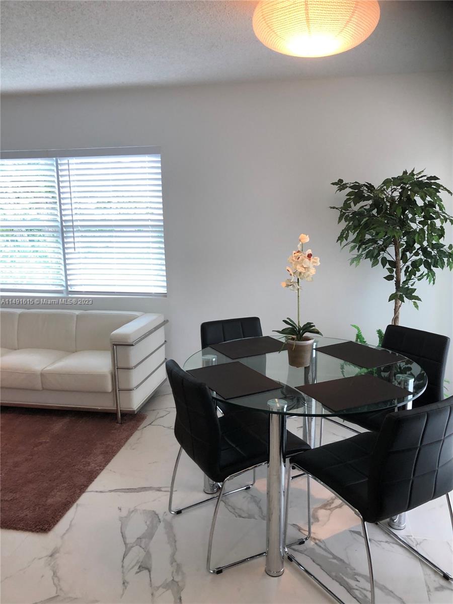 427 Southwest 7th Street, Unit 15 Miami, FL 33130 - Photo 9 of 25 a living room with furniture and a potted plant