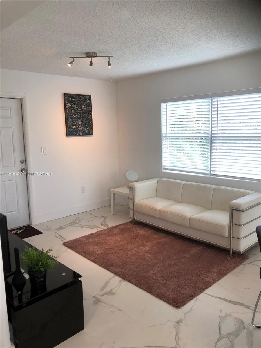 427 Southwest 7th Street, Unit 15 Miami, FL 33130 - Photo 10 of 25 a living room with furniture and a window