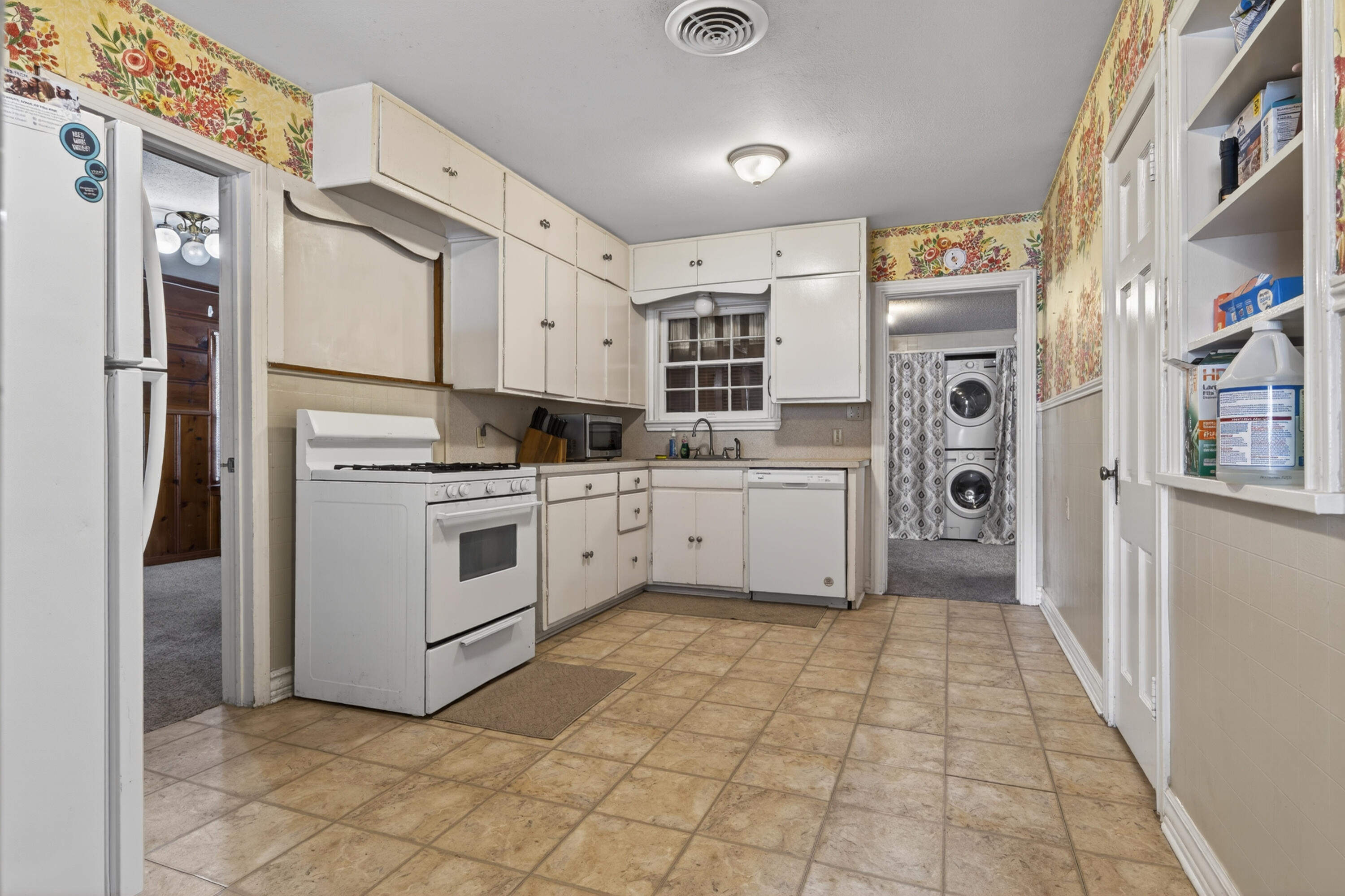 2212 22nd Street Lubbock, TX 79411 - Photo 4 of 14 a kitchen with white cabinets and white appliances