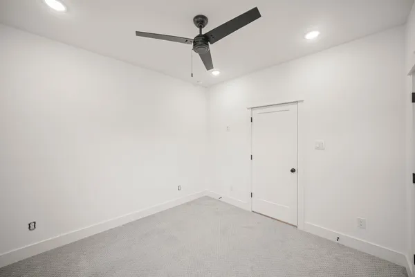 a view of empty room with ceiling fan