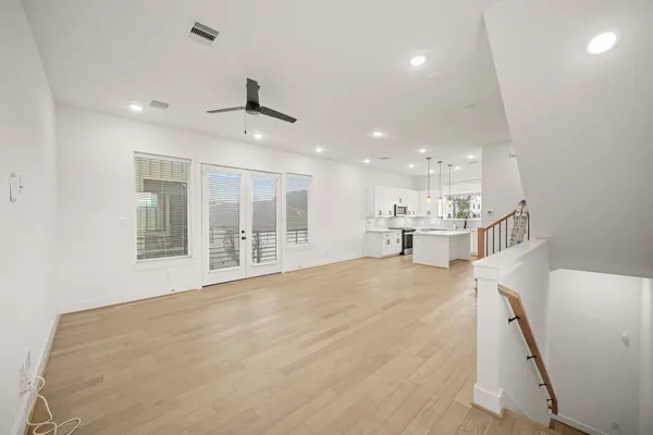 a view of an empty room with a kitchen