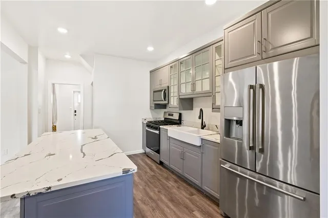 a kitchen with stainless steel appliances a refrigerator sink and cabinets