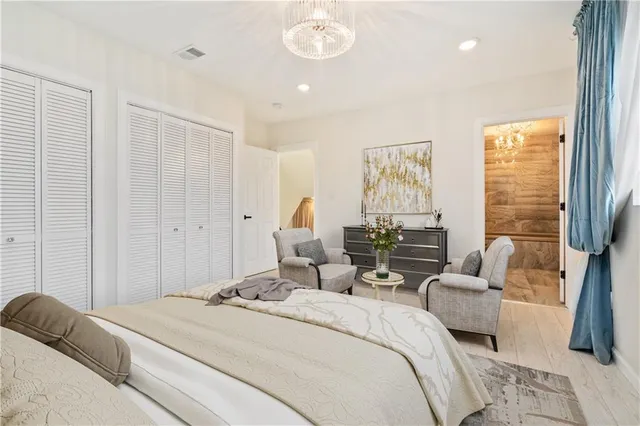 a bedroom with a bed and a chandelier