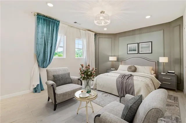 a spacious bedroom with a bed and a couch