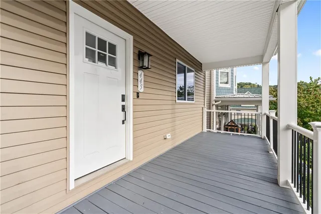 a view of a house with wooden deck