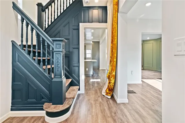 a view of an entryway with wooden floor and door