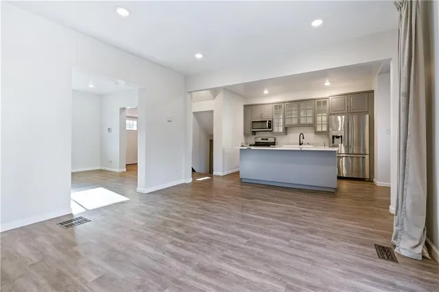 a view of kitchen and hall with wooden floor