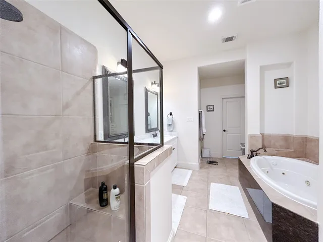 a bathroom with a bathtub and a shower