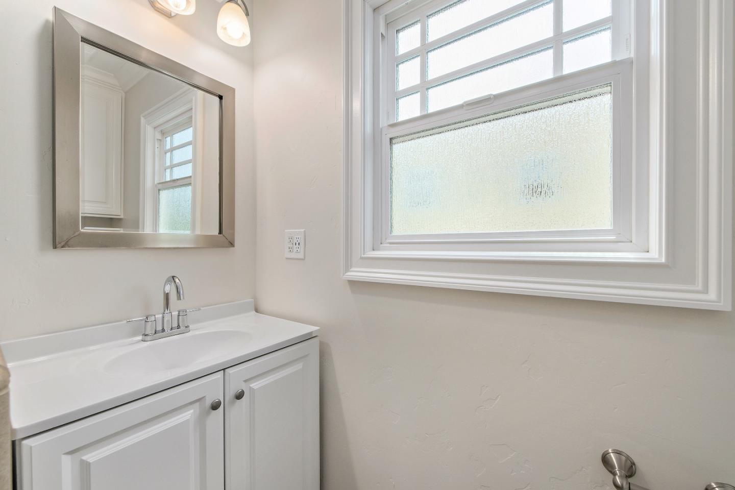 682 Second Avenue Redwood City, CA 94063 - Photo 14 of 18 a bathroom with a sink mirror and a window