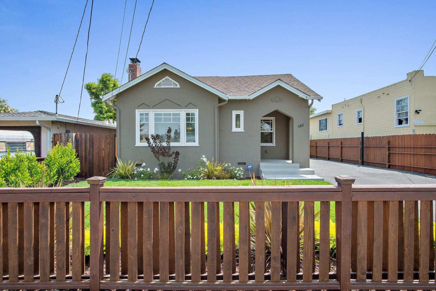 682 Second Avenue Redwood City, CA 94063 - Photo 2 of 18 a front view of a house with wooden fence