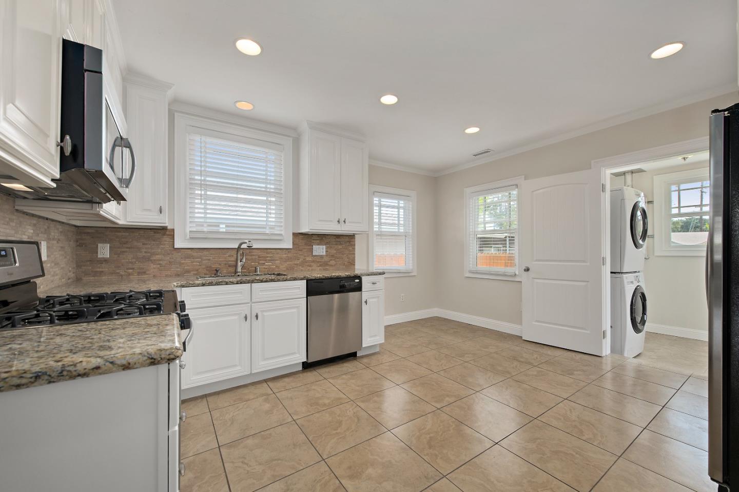 682 Second Avenue Redwood City, CA 94063 - Photo 8 of 18 a kitchen with granite countertop a stove a sink and a refrigerator