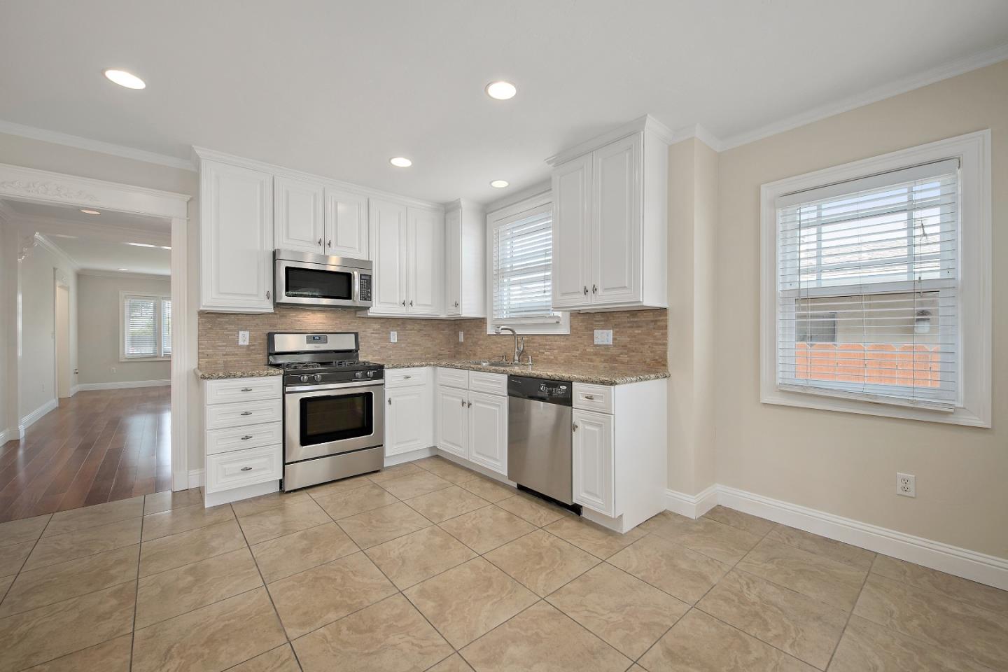 682 Second Avenue Redwood City, CA 94063 - Photo 9 of 18 a kitchen with granite countertop a stove sink and microwave