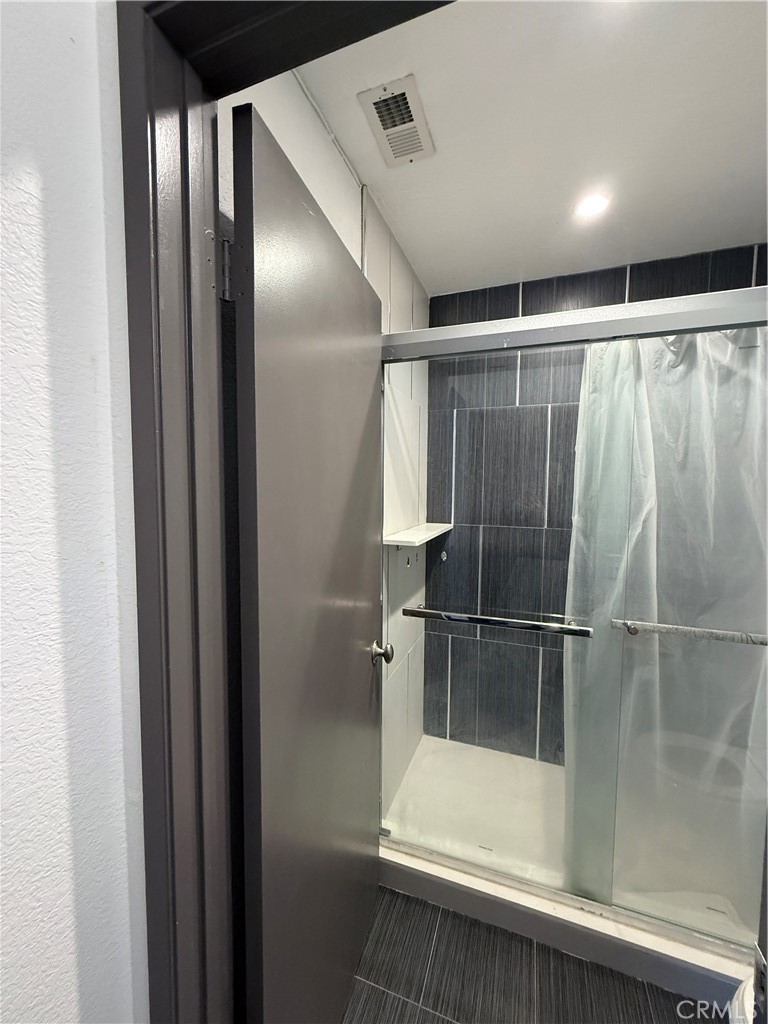 24316 Sylvan Glen Road, Unit G Diamond Bar, CA 91765 - Photo 13 of 23 a bathroom with a glass shower door