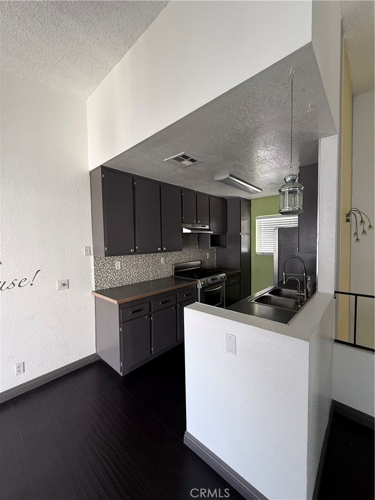 24316 Sylvan Glen Road, Unit G Diamond Bar, CA 91765 - Photo 6 of 23 a kitchen with a sink a stove and cabinets
