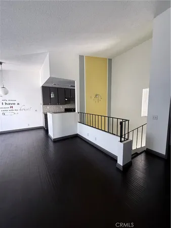 a view of a livingroom with wooden floor and a window