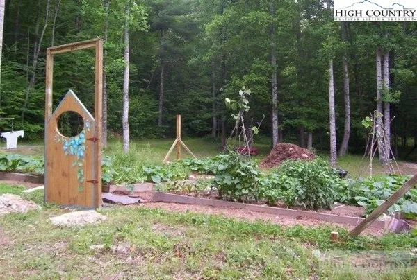 a backyard of a house with lots of green space and fountain