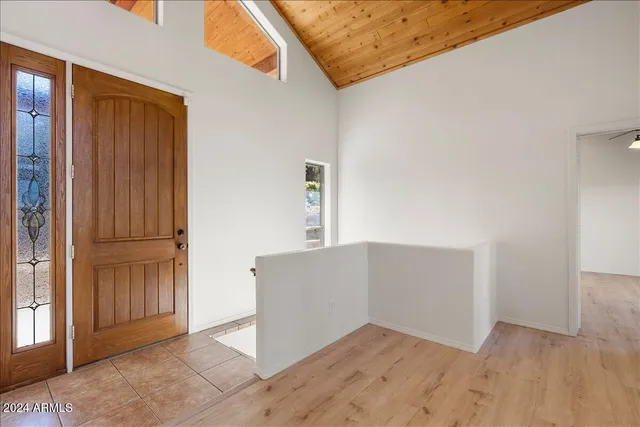 an empty room with wooden floor and cabinet
