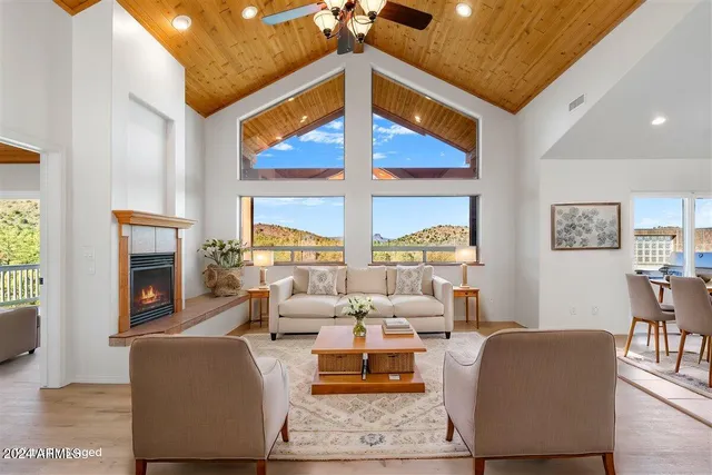 a living room with furniture fireplace and a table