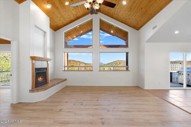 a view of a livingroom with wooden floor and a fireplace