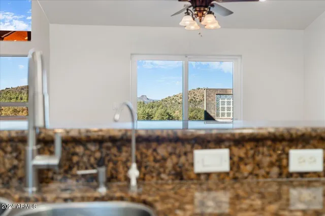 a view of a balcony with wooden floor and iron fence