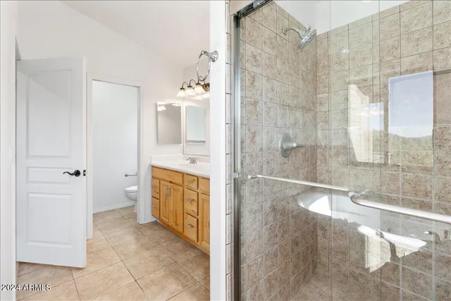 a balcony with wooden floor next to a building