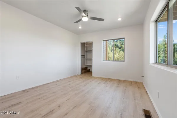 a room with a closet and white cabinet