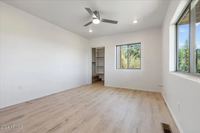a room with a closet and white cabinet
