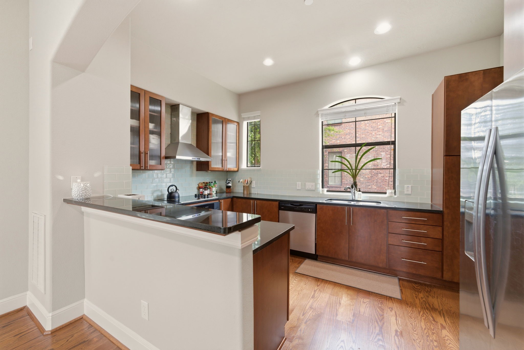 2110 Shearn Street, Unit 16 Houston, TX 77007 - Photo 6 of 37 Up the stairs with the groceries - Kitchen is at the top of the stairs! Breakfast bar for quick meals! Glass tile backsplash and windows for natural light! All stainless steel appliances and they will convey