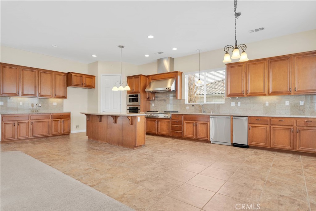 17830 Mana Road Apple Valley, CA 92307 - Photo 13 of 46 a large kitchen with granite countertop a large counter top stainless steel appliances and cabinets