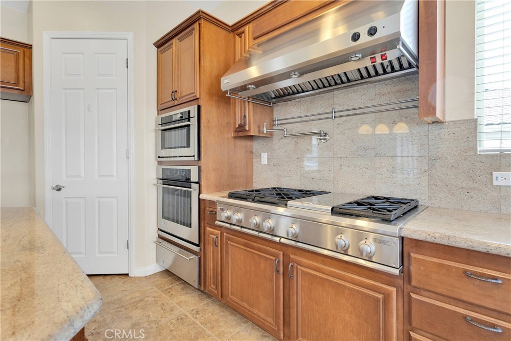 17830 Mana Road Apple Valley, CA 92307 - Photo 16 of 46 a kitchen with stainless steel appliances granite countertop a stove and a refrigerator