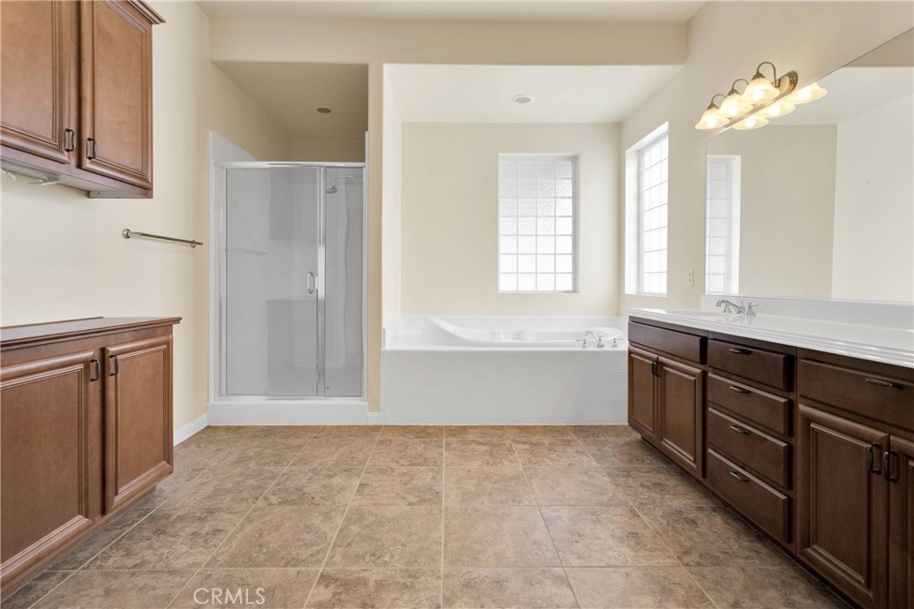 17830 Mana Road Apple Valley, CA 92307 - Photo 26 of 46 a bathroom with a sink vanity and a mirror