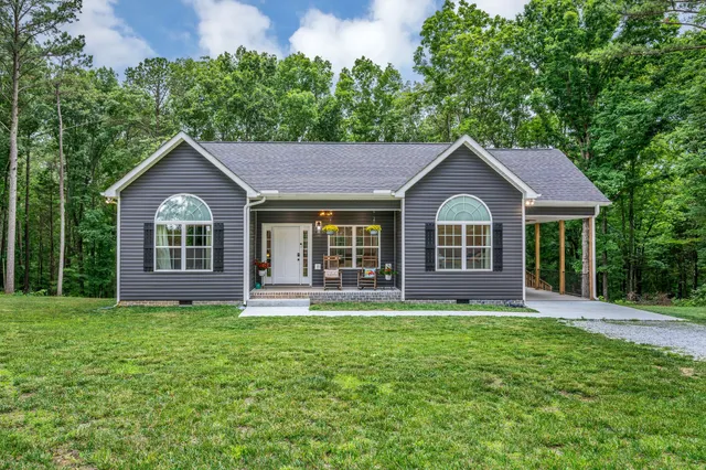 a front view of a house with a yard and porch