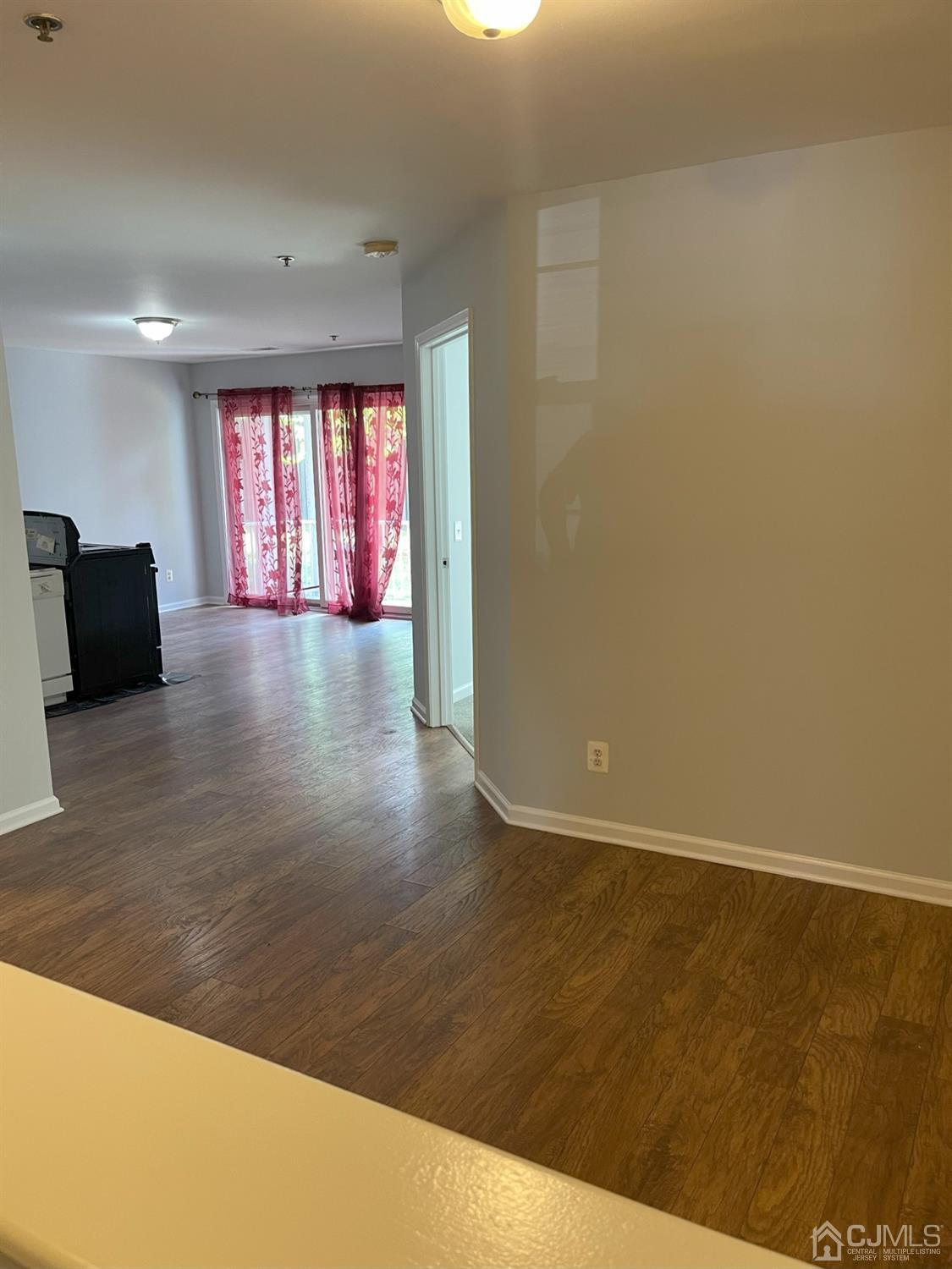 1113 Edpas Road New Brunswick, NJ 08901 - Photo 3 of 13 an empty room with wooden floor and windows